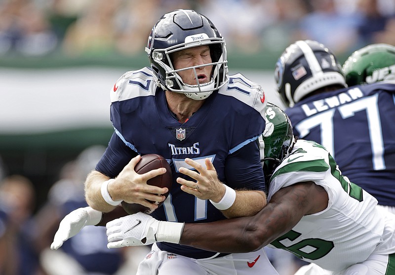 AP photo by Adam Hunger / Tennessee Titans quarterback Ryan Tannehill is sacked by New York Jets outside linebacker Quincy Williams during Sunday's game in East Rutherford, N.J. Tannehill has taken 17 sacks and been hit 32 times in all through four games this season.