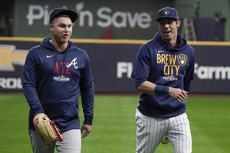 AP photo by Morry Gash / The Milwaukee Brewers' Christian Yelich, right, talks to the Atlanta Braves' Joc Pederson on Thursday in Milwaukee as their teams prepared to meet in an NL Division Series that starts Friday.