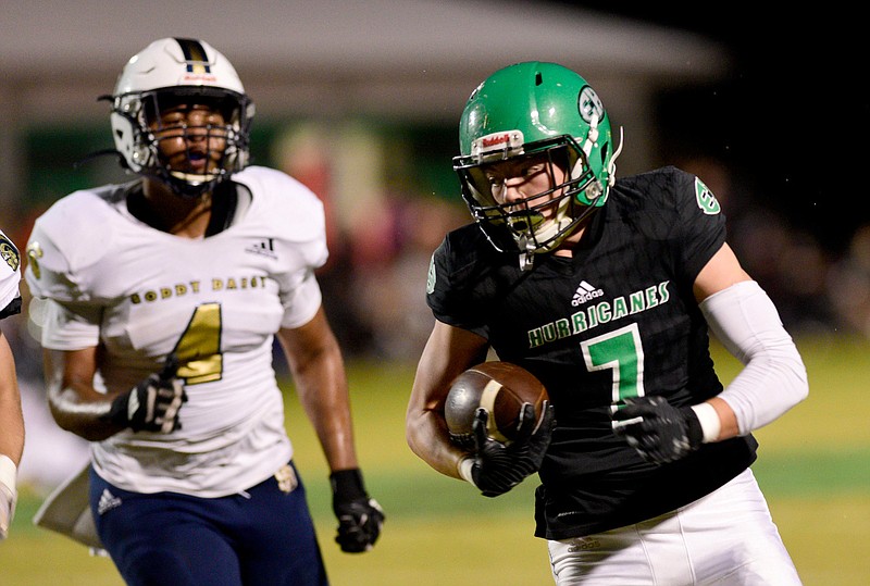 Staff photo by Robin Rudd / East Hamilton's Jaxon Flemmons (7) picks up yardage after making a catch as Soddy-Daisy's Jordan Conley chases him during a Region 3-4A game Thursday night at East Hamilton.