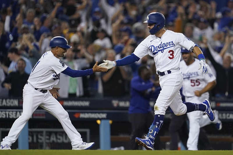 Los Angeles Dodgers' Chris Taylor (3) celebrates with third base coach Dino Ebel as he runs the bases after hitting a home run during the ninth inning to win a National League Wild Card playoff baseball game 3-1 over the St. Louis Cardinals Wednesday, Oct. 6, 2021, in Los Angeles. Cody Bellinger also scored. (AP Photo/Marcio Jose Sanchez)


