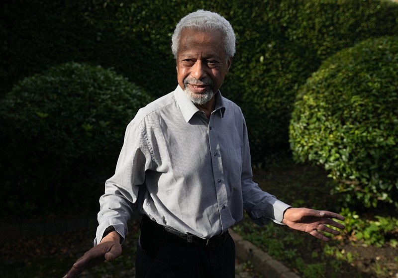 Tanzanian writer Abdulrazak Gurnah gestures as he poses for a photo at his home in Canterbury, England, Thursday, Oct. 7, 2021. Gurnah was awarded the Nobel Prize for Literature earlier on Thursday. The Swedish Academy said the award was in recognition of his "uncompromising and compassionate penetration of the effects of colonialism." (AP Photo/Frank Augstein)