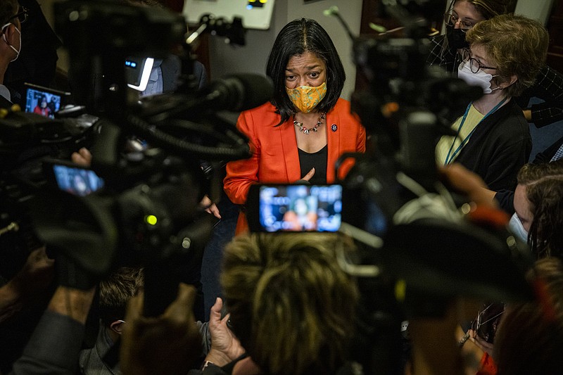 Photo by Samuel Corum of The New York Times / Rep. Pramila Jayapal, D-Washington, center, speaks to reporters outside a House Democrat caucus meeting at the Capitol in Washington on Oct. 1, 2021.