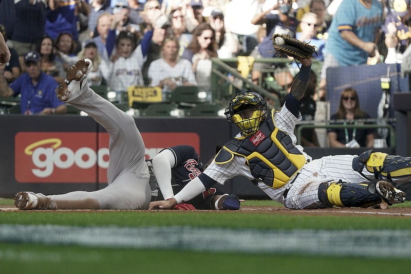 AP photo by Morry Gash / The Atlanta Braves' Jorge Soler is tagged out at the plate by Milwaukee Brewers catcher Omar Narvaez during the first inning of Friday's NLDS opener in Milwaukee. The Brewers won 2-1.