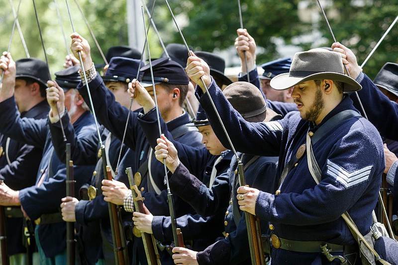 Staff photo by Doug Strickland / Civil War re-enactors, also known as living historians, demonstrate how to load firearms during a Civil War rifle firing demonstration program at Chickamauga and Chattanooga National Military Park's Point Park location on Saturday, July 6, 2019, in Lookout Mountain, Tenn.