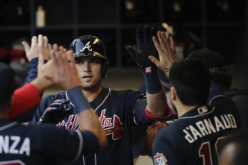 AP photo by Aaron Gash / Atlanta Braves third baseman Austin Riley, center, is congratulated in the dugout after hitting a home run during the sixth inning of Saturday's NLDS game against the host Milwaukee Brewers.