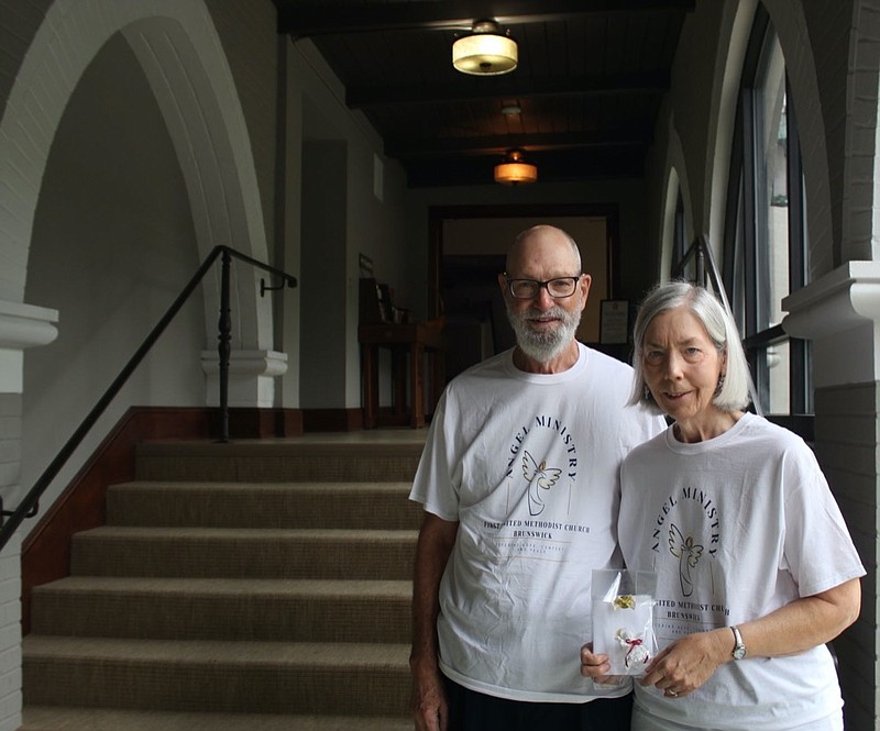 In this Oct. 2021 photo, Alan, left, and Ellen Huth stand in the foyer of First United Methodist Church in Brunswick, Ga. Ellen is holding one of the angels the ministry sends to those who need to be uplifted in trying times. (Lindsey Adkison/The Brunswick News via AP)


