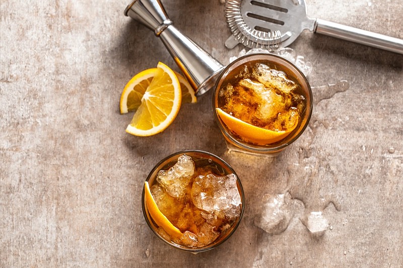 Cocktail Old fashioned Negroni with orange on the bar counter - stock photo cocktail alcohol tile / Getty Images
