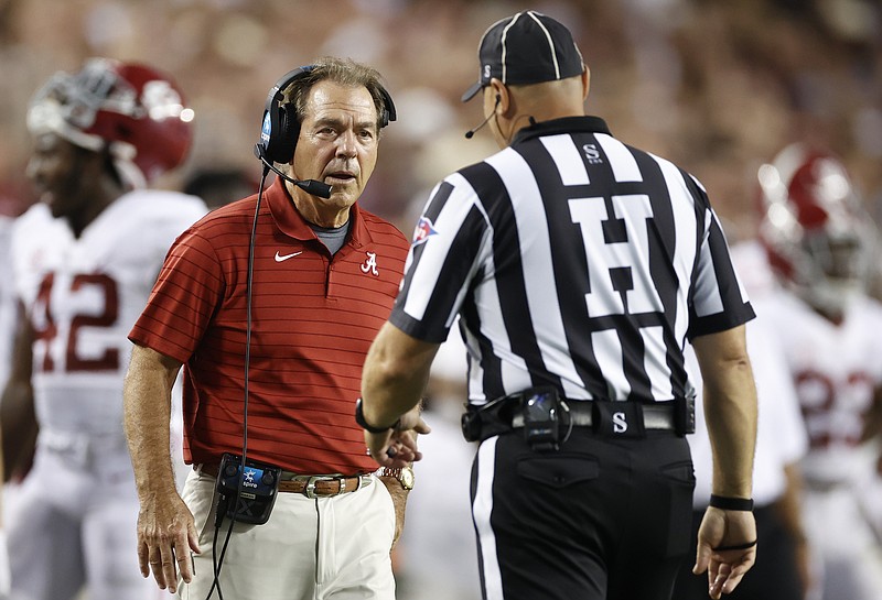 Alabama photo by Kent Gidley / Alabama football coach Nick Saban talks to an official during Saturday night's 41-38 loss at Texas A&M, which ended the Crimson Tide's 19-game winning streak.