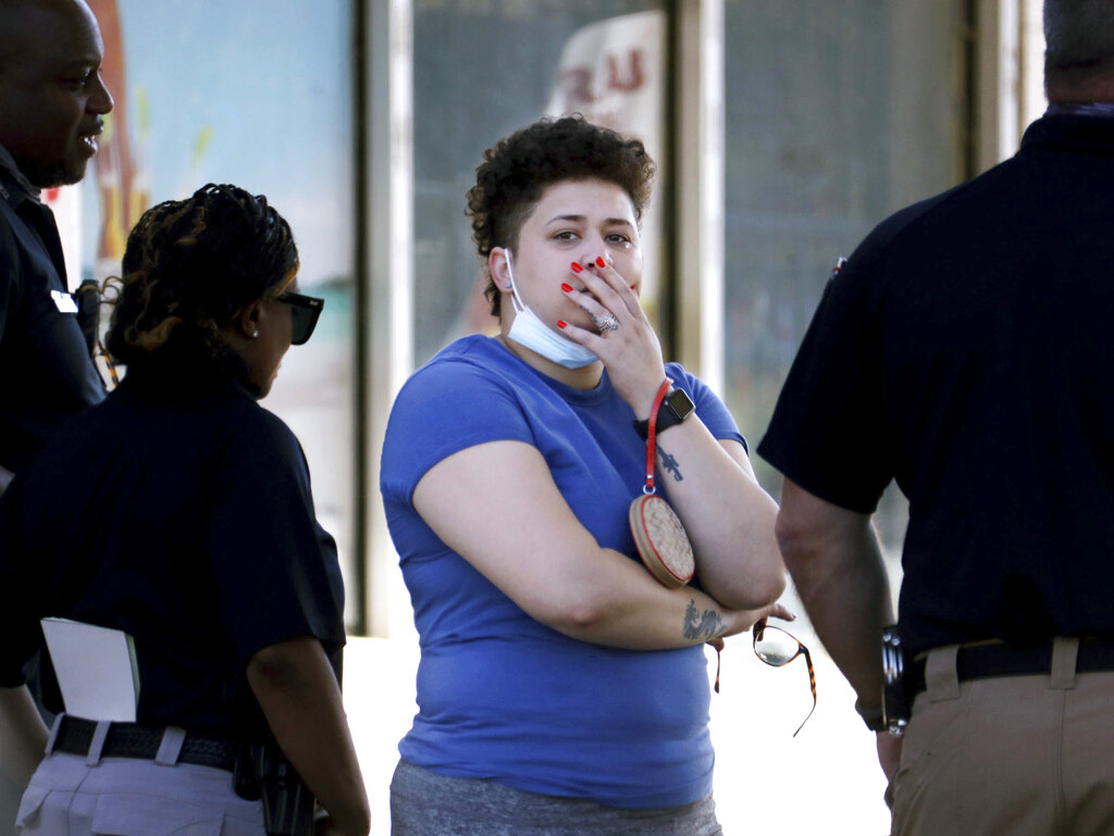 Family members of victims wait with Memphis Police Department officers outside of a post office after a shooting, Tuesday, Oct. 12, 2021 in the Orange Mound neighborhood of Memphis, Tenn. Police investigated a shooting Tuesday at a post office in an historic neighborhood of Memphis, Tennessee, the third high-profile shooting in the region in weeks.(Patrick Lantrip/Daily Memphian via AP)