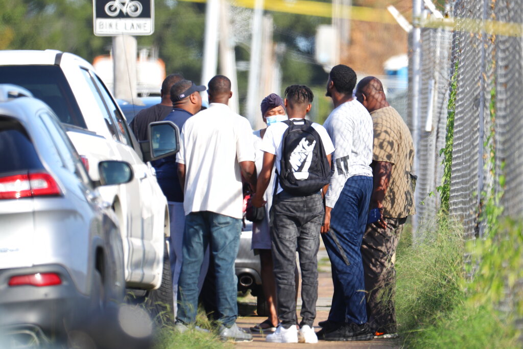 Family members of victims and employees pray outside of a post office after a shooting, Tuesday, Oct. 12, 2021 in the Orange Mound neighborhood of Memphis, Tenn. Police investigated a shooting Tuesday at a post office in an historic neighborhood of Memphis, Tennessee, the third high-profile shooting in the region in weeks.(Patrick Lantrip/Daily Memphian via AP)