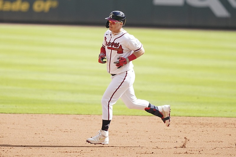 Atlanta Braves' Joc Pederson (22) rounds second base after hitting a three-run homer against the Milwaukee Brewers during the fifth inning of Game 3 of a baseball National League Division Series, Monday, Oct. 11, 2021, in Atlanta. (AP Photo/Brynn Anderson)