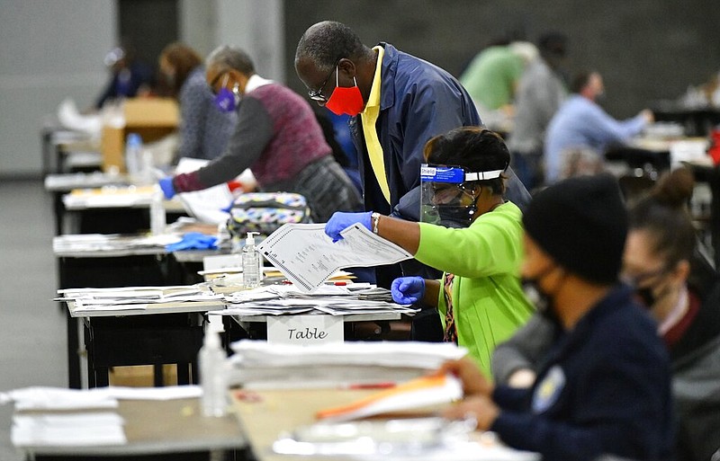 In this Saturday, Nov. 14, 2020, file photo, election workers in Fulton County began working through a recount of ballots in Atlanta. Investigators with Georgia's secretary of state's office have not found any evidence to substantiate claims that fraudulent or counterfeit ballots were counted in Fulton County during the 2020 general election. Henry County Superior Court Chief Judge Brian Amero is presiding over a lawsuit that alleges fraud in Fulton County during last year's election. (Hyosub Shin/Atlanta Journal-Constitution via AP, File)