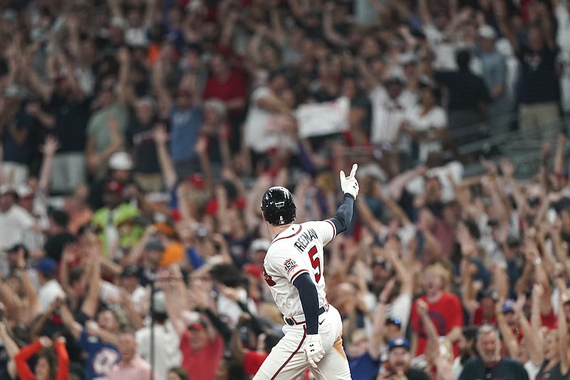 Atlanta Braves' Freddie Freeman (5) celebrates his solo homerun during the eighth inning of Game 4 of a baseball National League Division Series against the Milwaukee Brewers, Tuesday, Oct. 12, 2021, in Atlanta. (AP Photo/Brynn Anderson)