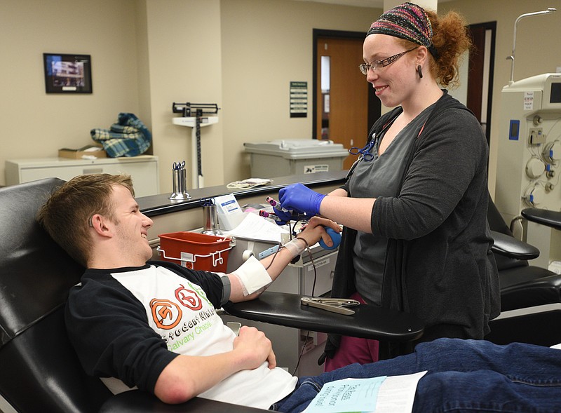 Staff Photo / Donor Andrew Dickerson, left, talks with training coordinator Brandy Womack on Tuesday, Nov. 22, 2016, at Blood Assurance. Dickerson, a University of Tennessee at Chattanooga student, came to donate blood after hearing pleas for donations for bus crash victims.