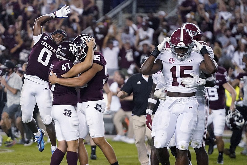 AP photo by Sam Craft / Texas A&M kicker Seth Small (47) celebrates with Nik Constantinou (95) and Ainias Smith (0) after he made the winning field goal, while Alabama linebackers Dallas Turner (15) and Will Anderson Jr., obscured, leave the field Saturday night in College Station, Texas.