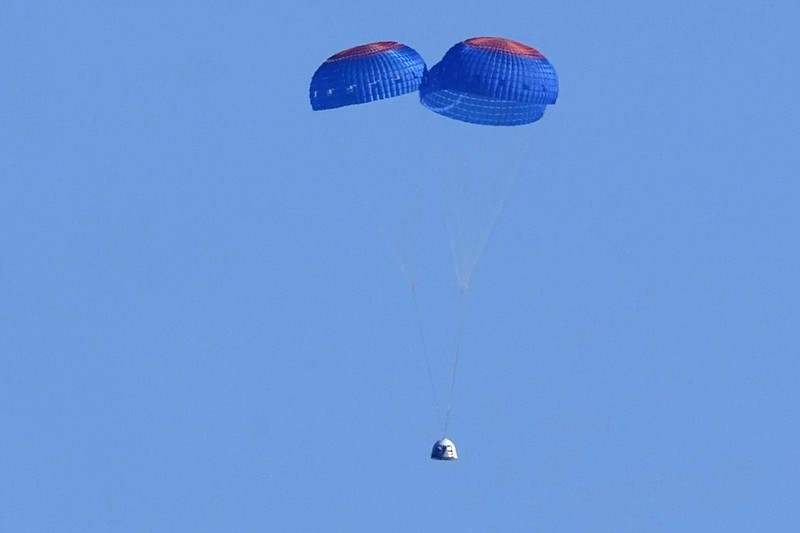 Parachutes slow the descent of the Blue Origin capsule with passengers William Shatner, Chris Boshuizen, Audrey Powers and Glen de Vries near the company's spaceport near Van Horn, Texas, Wednesday, Oct. 13, 2021. (AP Photo/LM Otero)