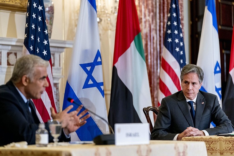 Israeli Foreign Minister Yair Lapid, left, accompanied by Secretary of State Antony Blinken, right, speaks at a joint news conference at the State Department in Washington, Wednesday, Oct. 13, 2021. (AP Photo/Andrew Harnik, Pool)