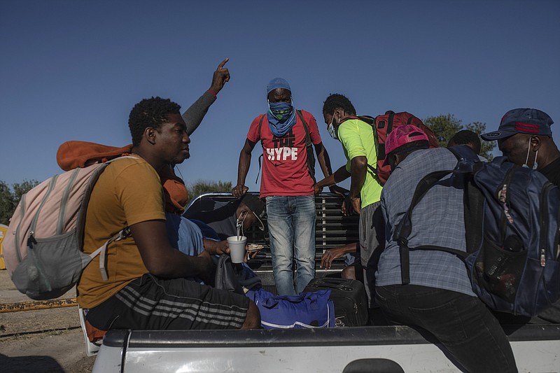 Photo by Felix Marquez of The Associated Press / Migrants board the back of a truck at an encampment after agreeing to be transferred to a shelter in Ciudad Acuna, Mexico on Sept. 24, 2021, across the Rio Grande from Del Rio, Texas.
