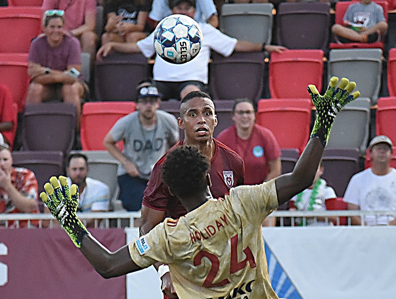 Staff photo by Matt Hamilton / The Chattanooga Red Wolves' Juan Galindrez chips the ball over North Carolina FC's Nicholas Holliday (24) for a goal during a USL League One match on June 20 at CHI Memorial Stadium in East Ridge.