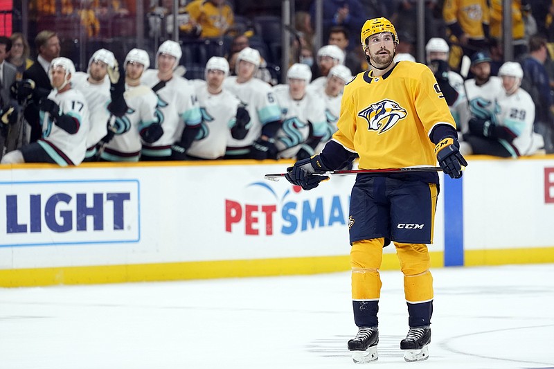 AP photo by Mark Humphrey / Nashville Predators left wing Filip Forsberg looks up at the scoreboard as Seattle Kraken players celebrate behind him after they scored a goal late in the third period of Thursday night's game in Nashville.