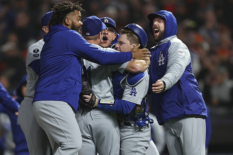 AP photo by John Hefti / The Los Angeles Dodgers celebrate after beating the host San Francisco Giants 2-1 on Thursday night to win the deciding Game 5 of their NL Division Series.
