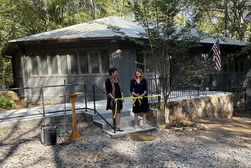 Staff photo by Dave Flessner / Welcome Home founder Sherry Campbell, right, and development director Sarah Quattrochi cut the ribbon on the first of three new homes the nonprofit is adding in the next year to its housing and care program for homeless Chattanoogans.