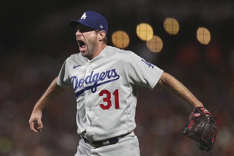 AP photo by Jed Jacobsohn / Los Angeles Dodgers pitcher Max Scherzer celebrates after getting the save Thursday night in Game 5 of the team's NL Division Series against the San Francisco Giants.