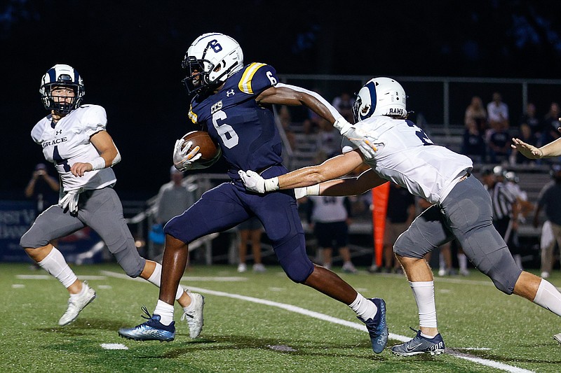 Staff photo by Troy Stolt / Chattanooga Christian running back Boo Carter (6) breaks a tackle on his way to a touchdown during Friday night's home win against Knoxville Grace.