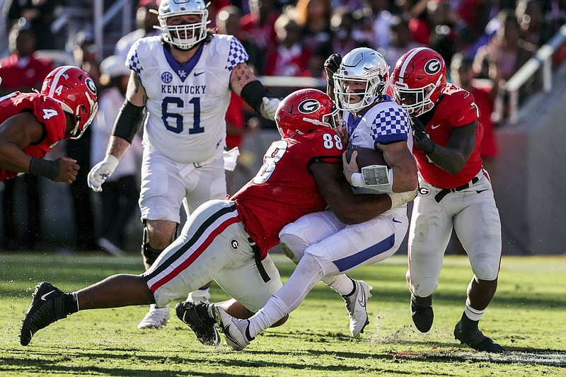 AP photo by Butch Dill / Kentucky quarterback Will Levis is sacked by Georgia defensive lineman Jalen Carter (88) and linebacker Quay Walker during the first half of Saturday's matchup of previously unbeaten SEC East teams in Athens, Ga. Top-ranked Georgia beat the 11th-ranked Wildcats 30-13.