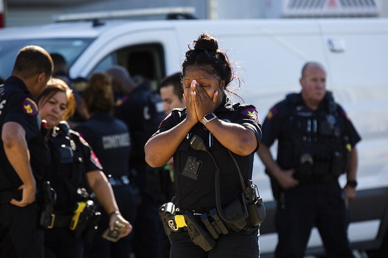 A Harris County Pct. 4 deputy exits the Harris County Institute of Forensic Sciences mourning the death of a deputy who was shot and killed in north Houston, Saturday, Oct. 16, 2021. Three constable deputies were shot in an ambush early Saturday morning while working an extra shift at a Houston bar. (Marie D. De Jesús/Houston Chronicle via AP)

