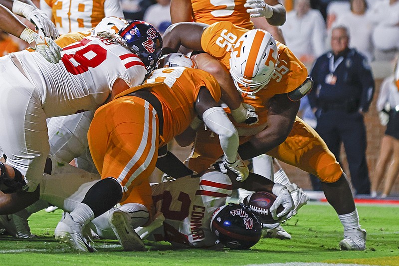 AP photo by Wade Payne / Ole Miss running back Snoop Conner, bottom, scores a touchdown as he's hit by Tennessee defensive linemen Da'Jon Terry (95) and Ja'Quain Blakely during the first half of Saturday night's game in Knoxville.