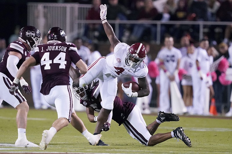 AP photo by Rogelio V. Solis / Alabama running back Brian Robinson Jr. (4) is upended by Mississippi State defenders after a short run during the first half of Saturday night's game in Starkville, Miss.