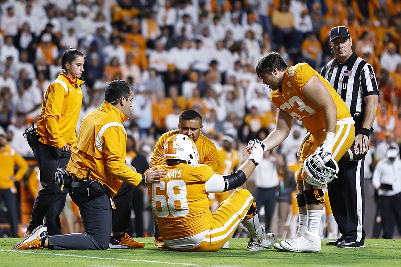 AP photo by Wade Payne / Tennessee's Cade Mays (68) is attended to after getting injured as his brother, fellow offensive lineman Cooper Mays helps him up during the first half of Saturday night's home game against Ole Miss.