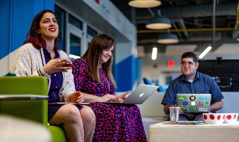 Staff photo by Troy Stolt / Members of the CO.LAB team (from left to right) Christine DiPietro, Chloe Morrison, and Zac Beker talk during a meeting about Startup Week in their office inside of the Edney Building on Wednesday.
