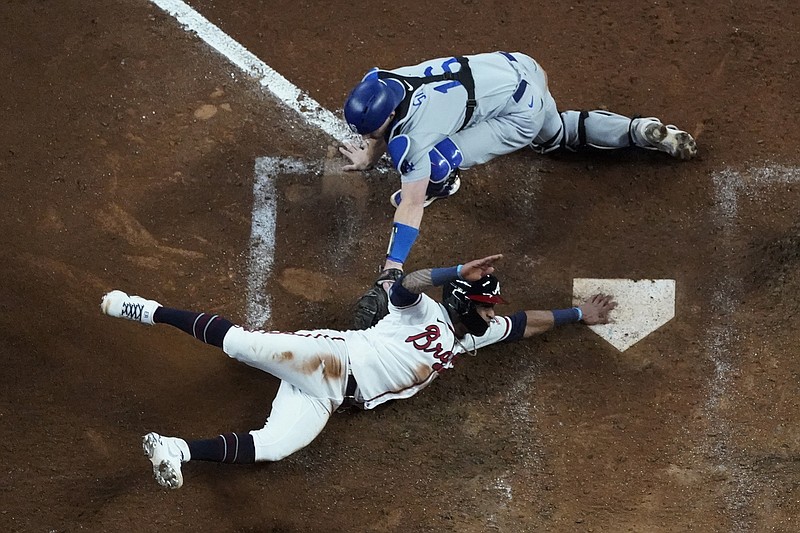 AP photo by John Bazemore / Los Angeles Dodgers catcher Will Smith can't make the tag as the Atlanta Braves' Ozzie Albies scores on a single by Austin Riley in the eighth inning in Game 2 of the NL Championship Series on Sunday night in Atlanta.