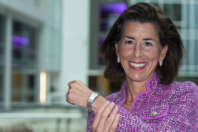 In this Tuesday, Sept. 28, 2021, photo Commerce Secretary Gina Raimondo poses for a photograph with her Bulova watch. Raimondo only wears watches made by Bulova — a company that fired her scientist father, closed its Rhode Island factory and moved production to China in 1983. "It's been a tribute to my dad," Raimondo said in an interview, "and a reminder to me that we need to do more to get good manufacturing jobs in America." (AP Photo/Alex Brandon)