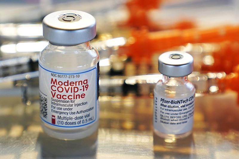 FILE - This Thursday, Feb. 25, 2021 file photo shows vials for the Moderna and Pfizer COVID-19 vaccines at a temporary clinic in Exeter, N.H. In September, 2021, the Food and Drug Administration approved extra doses of Pfizer's original COVID-19 vaccine after studies showed it still works well enough against the delta variant. And the FDA is weighing evidence for boosters of the original Moderna and Johnson & Johnson vaccines. (AP Photo/Charles Krupa)