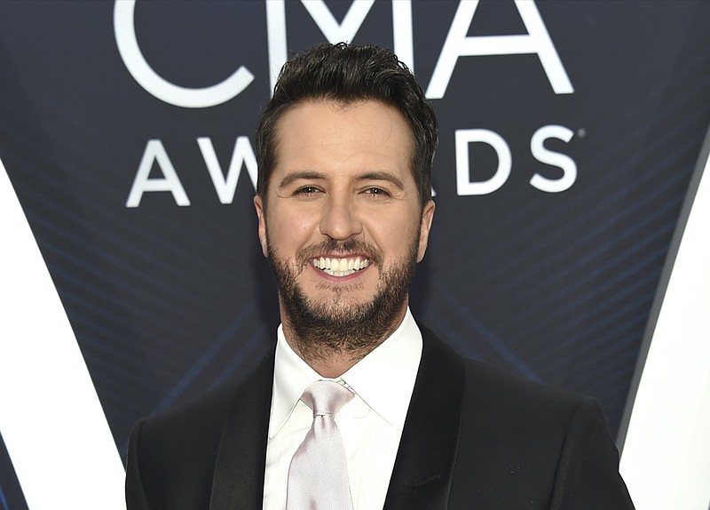 FILE - Luke Bryan arrives at the 52nd annual CMA Awards in Nashville, Tenn. on Nov. 14, 2018. Bryan will host the 55th Annual CMA Awards on Nov. 10. (Photo by Evan Agostini/Invision/AP, File)