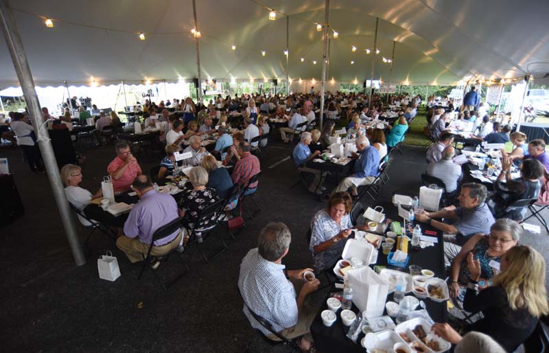 Staff Photo by Matt Hamilton / Guests enjoy dinner during the fundraiser.