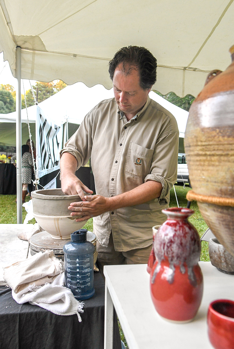 Photo by Mark Gilliland / Artist Loren Howard working on clay pots.