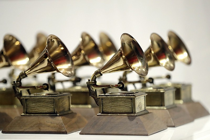 FILE - In this Oct. 10, 2017, file photo, various Grammy Awards are displayed at the Grammy Museum Experience at Prudential Center in Newark, N.J. The Grammys is sticking to its word with the public release of the full inclusion rider to ensure equity and inclusion on all levels of production for next year's ceremony. The Recording Academy released on Tuesday, Oct. 19, 2021, an eight-page document detailing the rider's purposes and objectives. The agreement will require producers to recruit and hire more diverse candidates backstage and in front of the camera for the 64th annual awards ceremony on Jan. 31. (AP Photo/Julio Cortez, File)