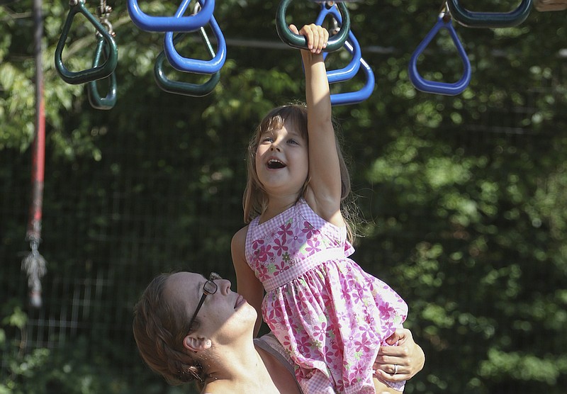THUMBNAIL ONLY: Staff file photo / Renee Barnett helped her then-4-year-old daughter cross the Ring Trek at the community park in St. Elmo in 2016. A child was injured in the area in June 2019, leading to a lawsuit that was recently settled with the city of Chattanooga.