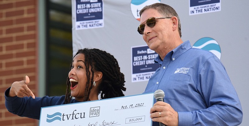 Staff Photo by Matt Hamilton / Tommy Nix presents a check to Briana Garza on Tuesday, October 19, 2021 at the Bessie Smith Cultural Center. The Tennessee Valley Federal Credit Union sponsored the Idea Leap pitch competition on Tuesday.