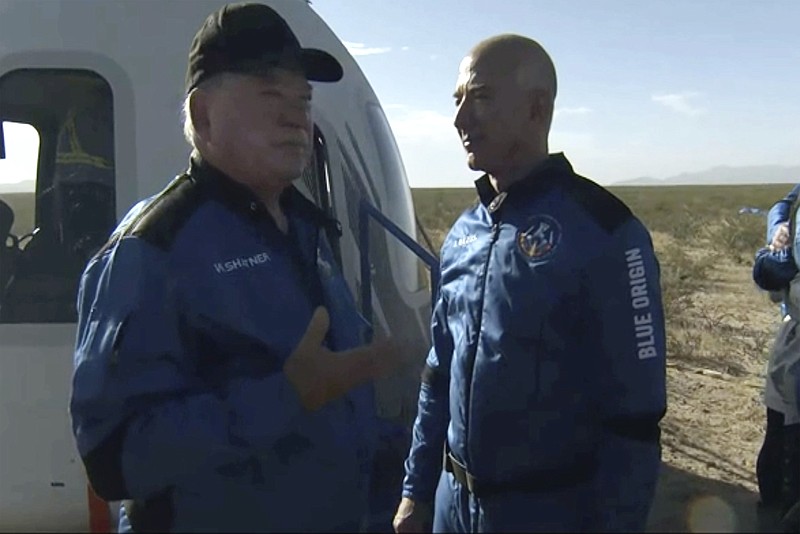 Photo courtesy of Blue Origin via The Associated Press / In this image provided by Blue Origin, William Shatner talks with Jeff Bezos about his experience after exiting the Blue Origin capsule near Van Horn, Texas, on Wednesday, Oct. 13, 2021.