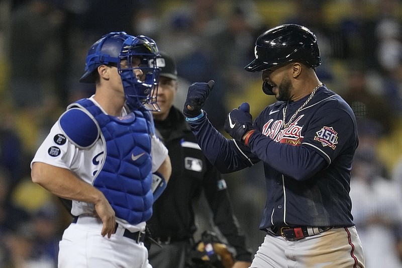 Atlanta Braves' Eddie Rosario celebrates as he walks past Los Angeles Dodgers catcher Will Smith after hitting a two-run home run in the ninth inning in Game 4 of baseball's National League Championship Series Wednesday, Oct. 20, 2021, in Los Angeles. (AP Photo/Ashley Landis)