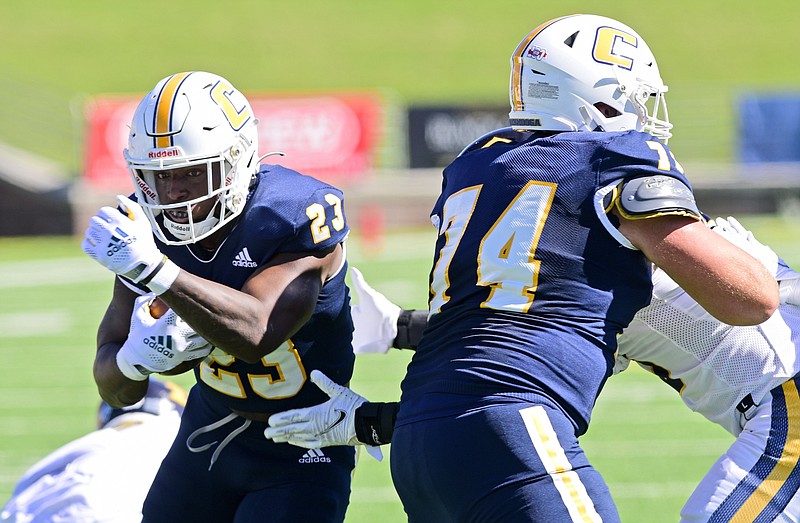 Staff photo by Robin Rudd / UTC running back Tyrell Price (23) moves behind the block of Colin Truett to score a touchdown during last Saturday's home win against SoCon rival East Tennessee State.