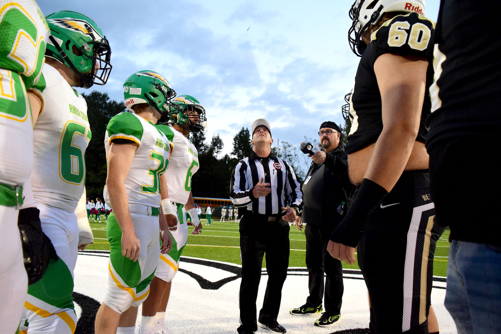 Staff Photo by Robin Rudd / Referee Keith Deakin tosses the coin in front of the captains. The Bradley Central Bears hosted the Rhea County Golden Eagles in a TSSAA football game on October 22, 2021.