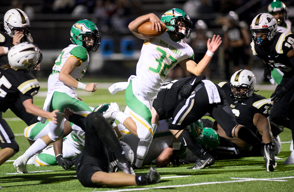 Staff photo by Robin Rudd / Rhea County's Ethan Davis (32) breaks through the defense during Friday night's game at Bradley Central. Davis rushed for 275 yards and four scores, and he also made the winning touchdown catch as the Golden Eagles knocked down the previously unbeaten Bears, 48-42.