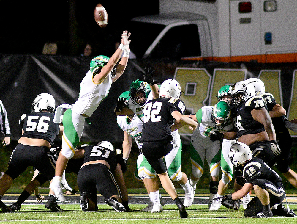 Staff Photo by Robin Rudd / Bradley's Grant Haney (82) kicks a extra point over the Golden Eagle defense, from the hold of Taylor Duggan (16). The Bradley Central Bears hosted the Rhea County Golden Eagles in a TSSAA football game on October 22, 2021.
