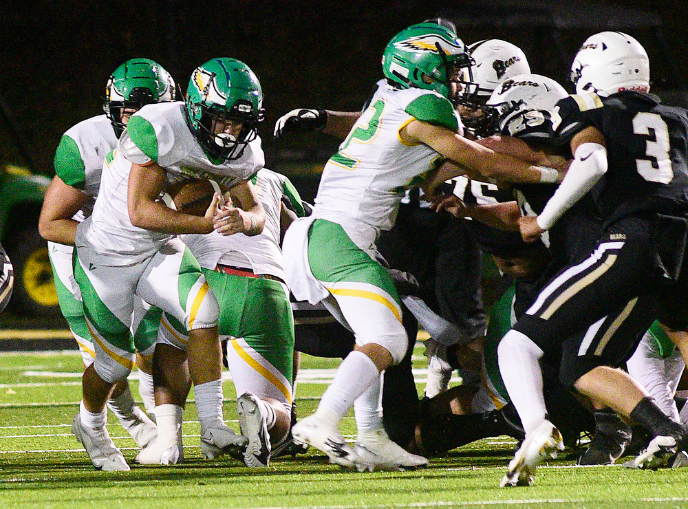 Staff Photo by Robin Rudd / Rhea quaterback Kaleb Martin (12) picks up yardage on a keeper. The Bradley Central Bears hosted the Rhea County Golden Eagles in a TSSAA football game on October 22, 2021.